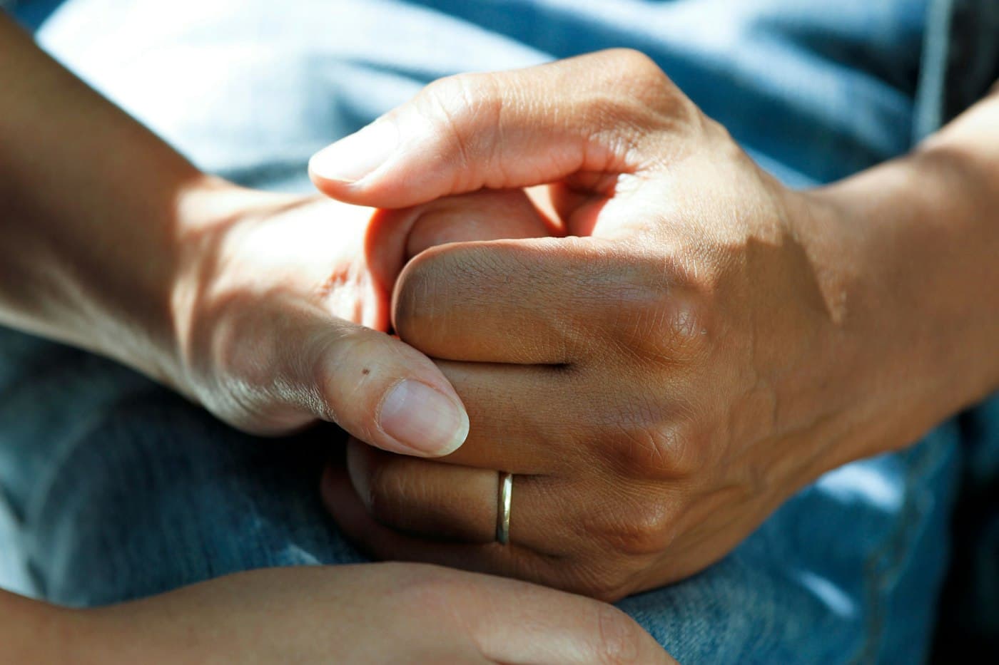 A family member holding a loved one's hand