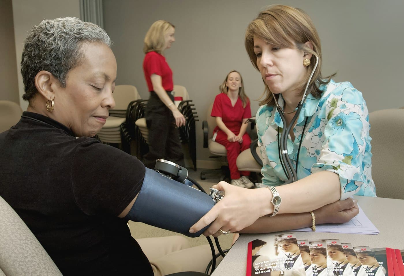 A nurse gently checking a patient's blood pressure